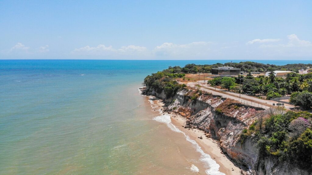 pexels-photo-3968211-3968211 Stunning aerial view of João Pessoa coastline with cliffs and beach meeting the Atlantic Ocean.