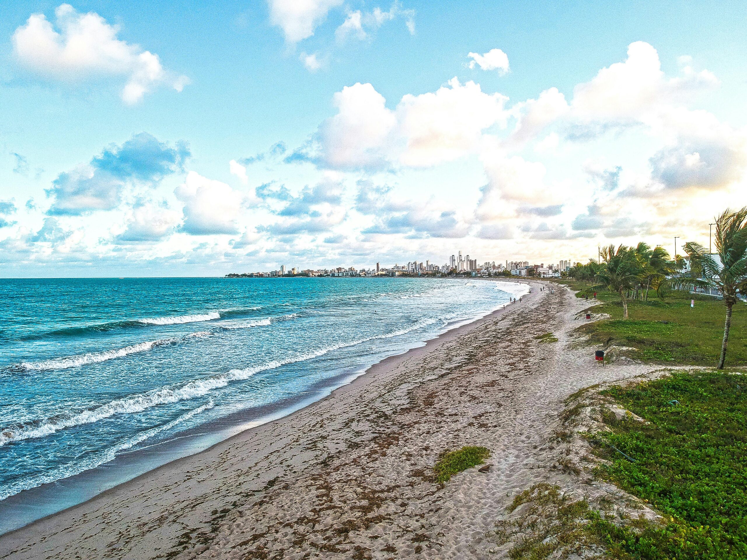 A serene view of Intermares beach in Brazil with waves and clear blue sky.